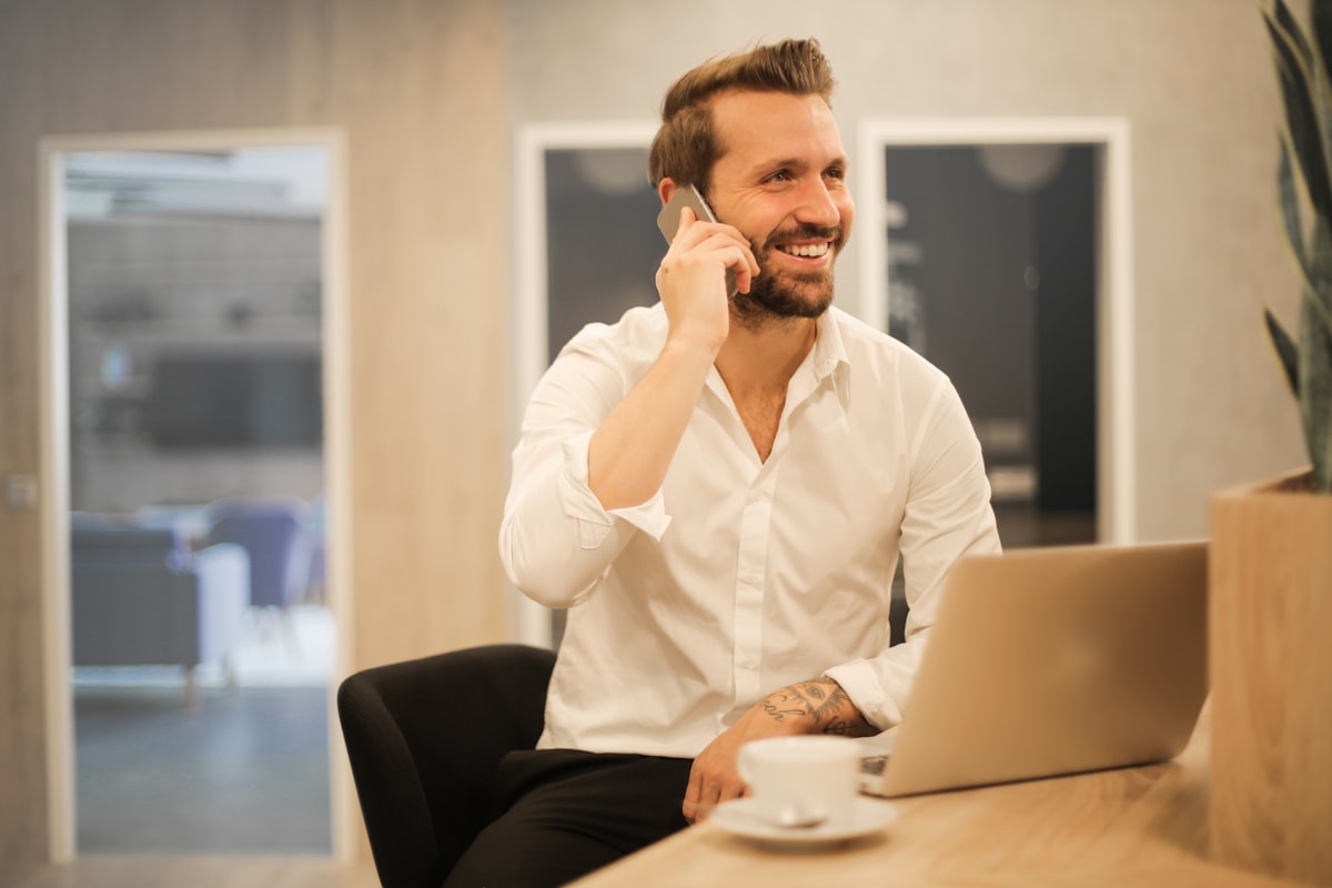 A man taking a business call at his desk