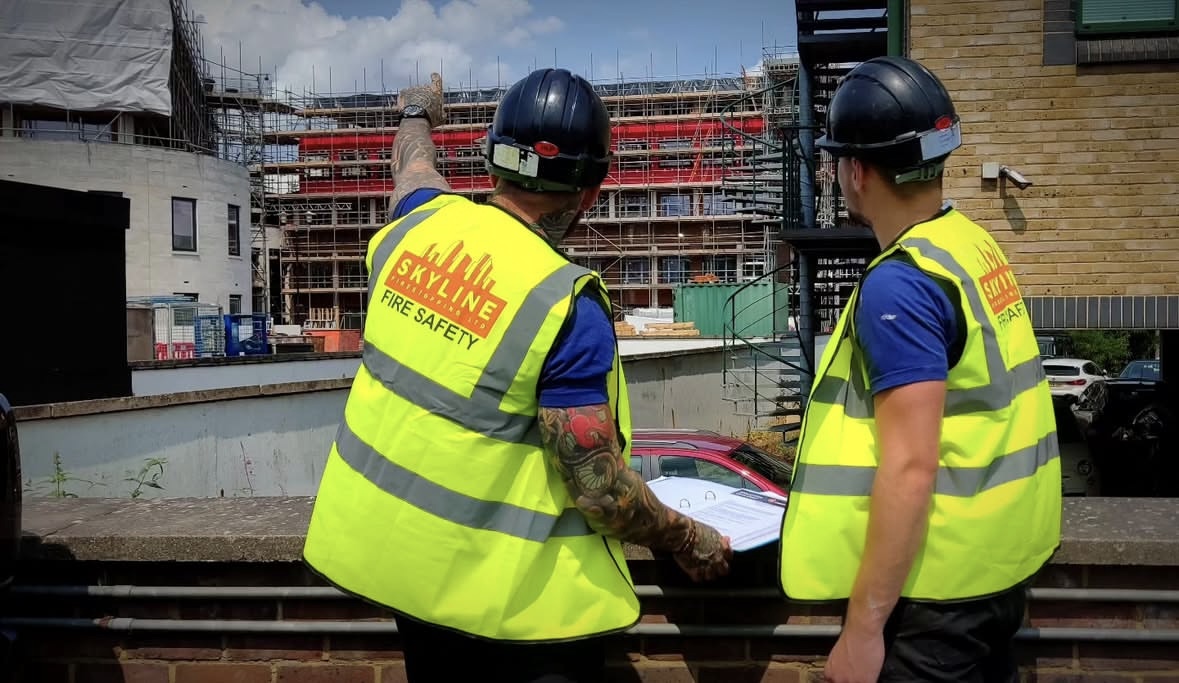 Skyline installers reviewing firestopping work on a live scheme