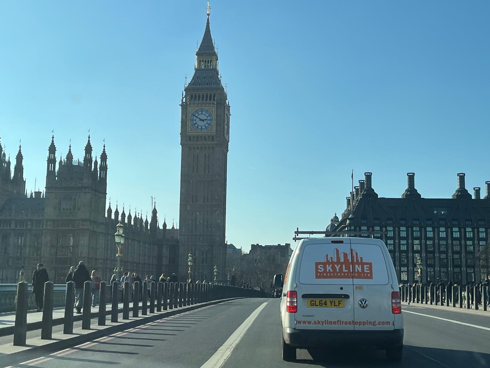 A white Skyline Firestopping van on Westminster Bridge, with Big Ben and the Houses of Parliament behind