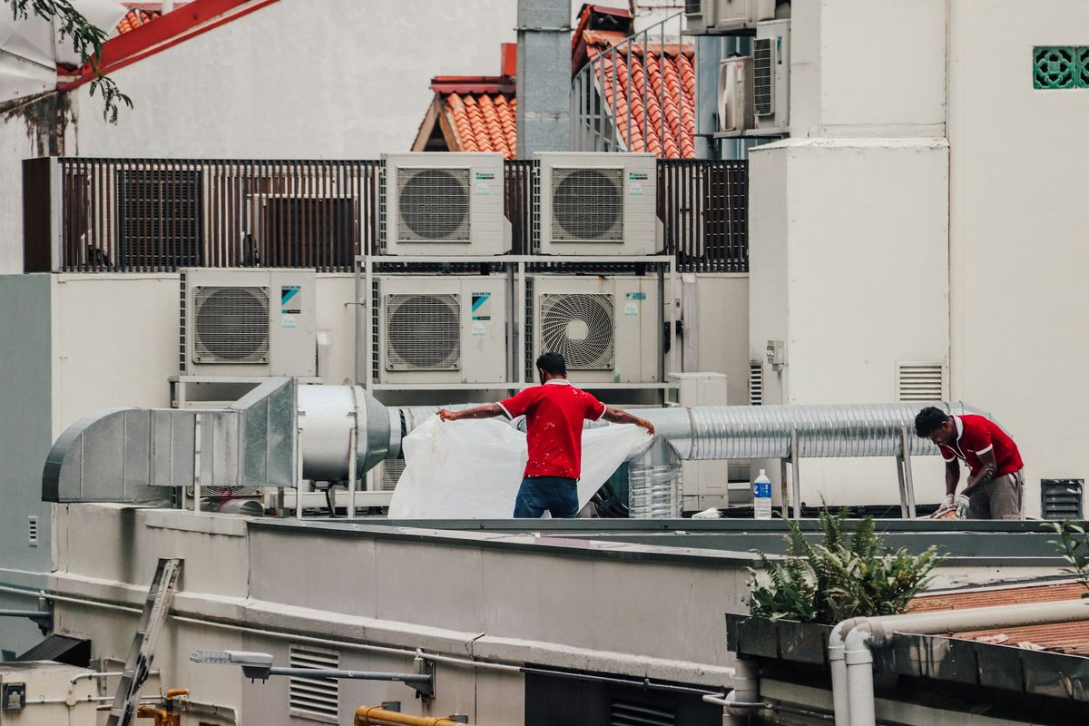 Tradespeople at work on a commercial rooftop