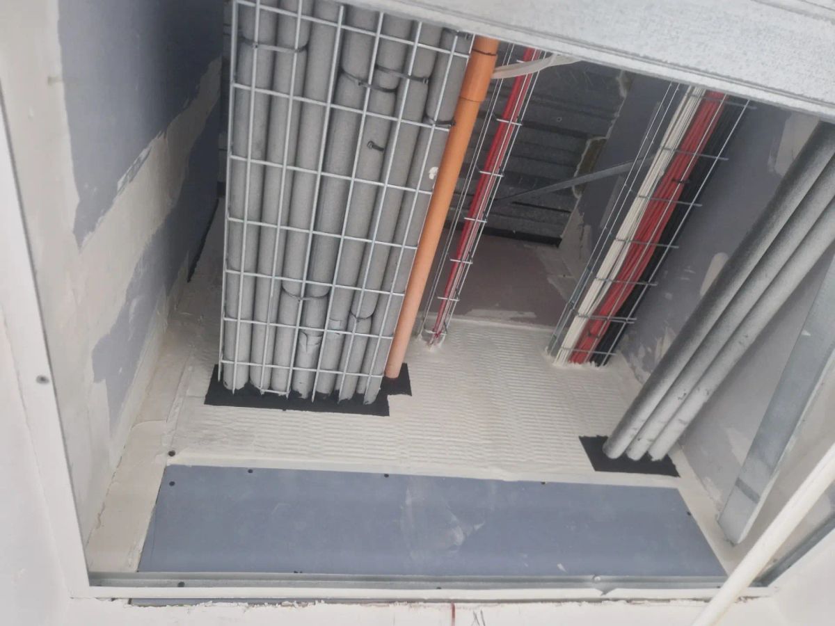 A breach logged on a fire compartmentation survey: service penetrations through a floor slab