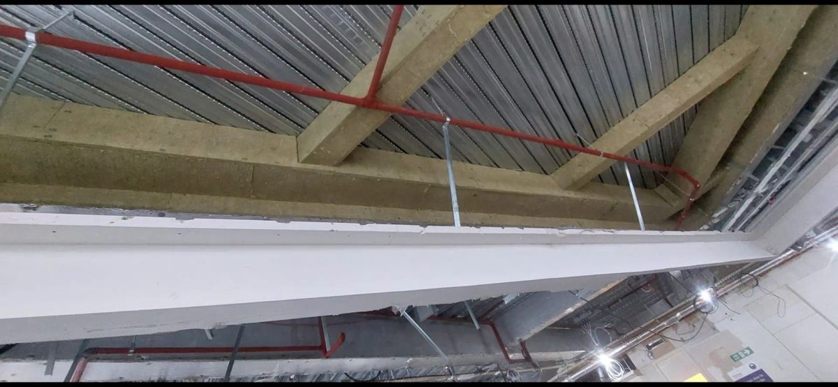 Structural steel coated on site, with intumescent coatings measured and recorded before cover-up